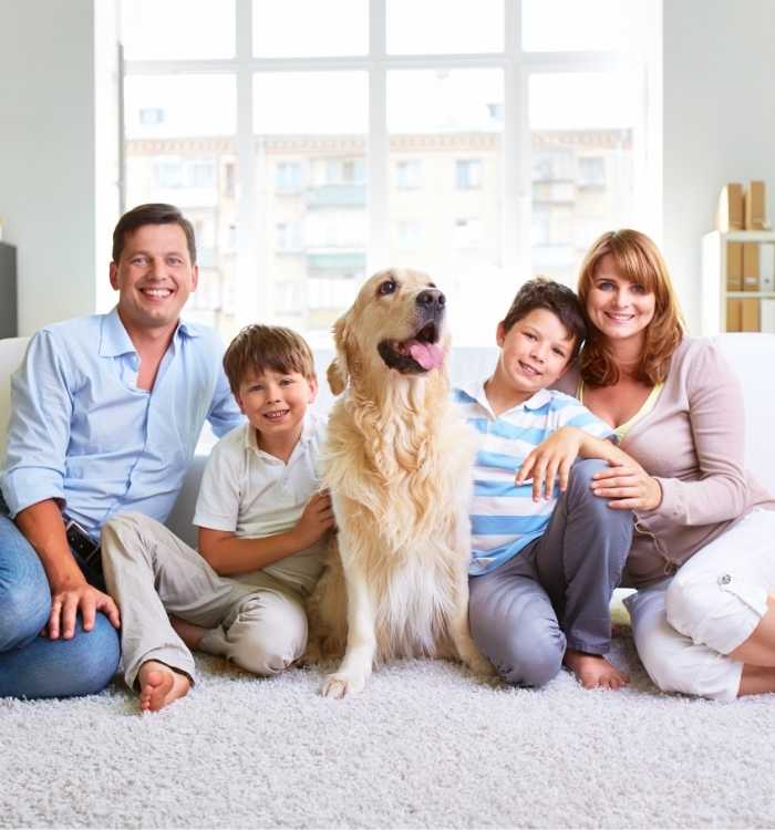 Happy Family with dog on carpet